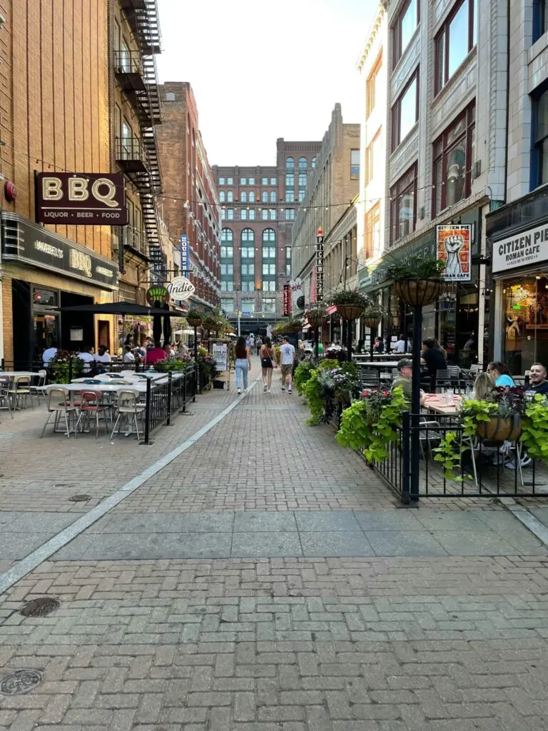 A brick road with tables and storefronts on either side in Cleveland, Ohio